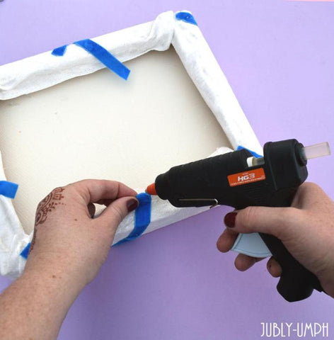 Glue the ribbon to the back of the board with the hot glue gun- Make this fun DIY brooch board on the Jubly-Umph blog