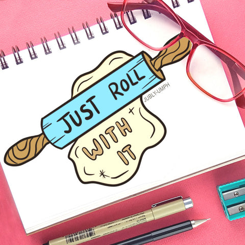 Print of a rolling pin with 'just roll with it' written on it