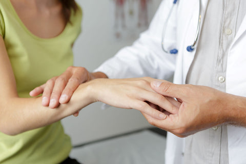 person being seen by a doctor for wrist pain