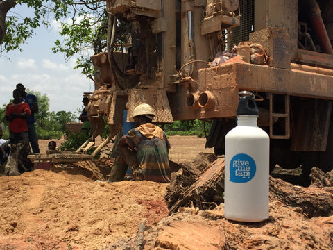 GiveMeTap water bottle at water pump in Africa, Ghana