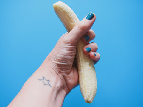 Women holding peeled banana