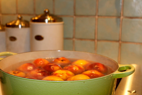 Bowl filled with water and peaches
