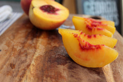 Freshly sliced peaches on a cutting board