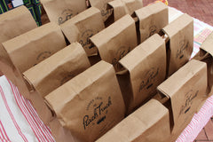 Rows of paper bags for The Peach Truck products