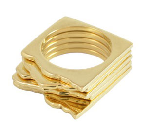 stack of five square gold rings that mimic mountains.