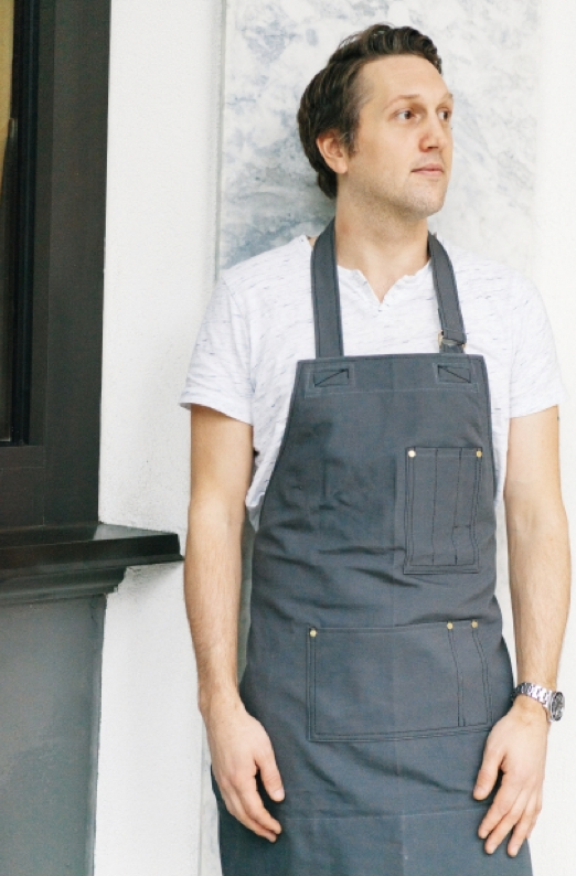 Co-Founder Stephen Collins Field and Social wearing Search and Rescue Denim Co Apron