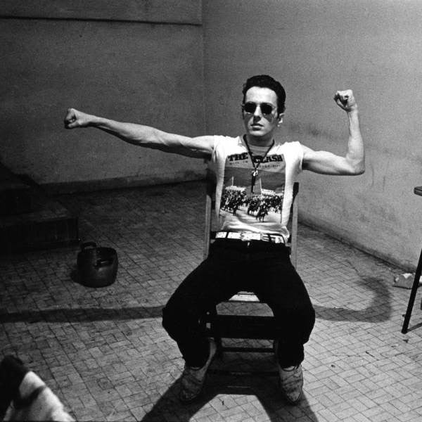 The Clash: In Milan, in 1981, Joe Strummer wears a Clash t-shirt. The band was anti-establishment and fans who wear the t-shirt align themselves with 70's punk rebellion. 