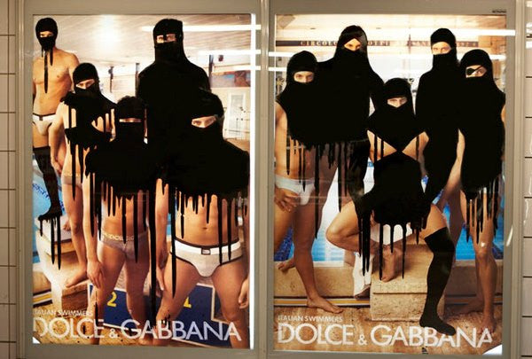 Dolce and Gabanna advert covered in graffiti