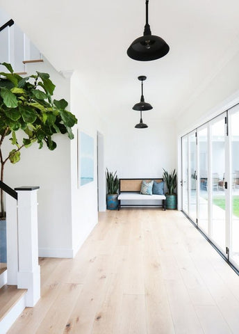 Natural lighting is best. During night time, this hallway gets illuminated by a row of handsome industrial pendant lights. 