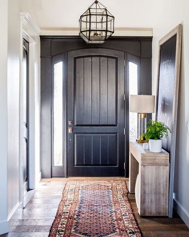 This black farmhouse entry exudes with a strong masculine flair.