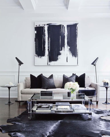 A pair of handsome floor lamps adds symmetry to this black and white masculine living room. Lighting Melbourne Australia