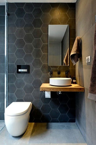 If you have chosen a neutral colour motif with your bath, adding geometric shapes helps to create a contemporary twist to your powder room.