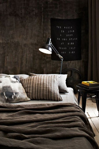 Its dark, earthy colours make this masculine themed bedroom largely industrial