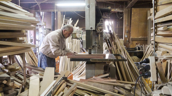 Master Nidome working in his cluttered workshop