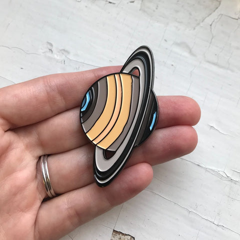 Saturn enamel pin, illustrated by Lauren Beacham of Yugen Tribe