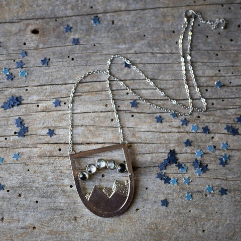 Landscape pendant necklace with mountains and phases of the moon