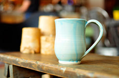 pottery mugs on shelf
