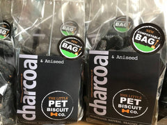 Charcoal dog biscuits in a compostable bag