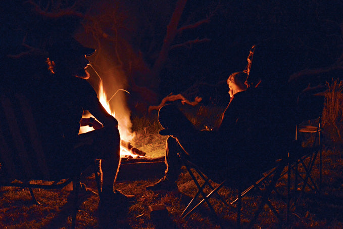 Adam Stickland chatting around open camp fire