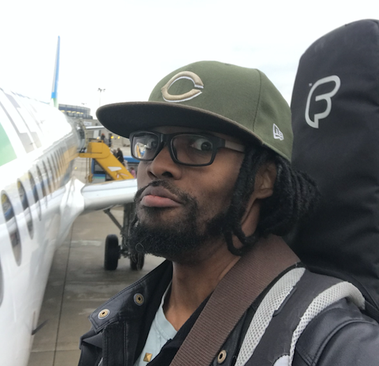 Is Josiah Woodson going to get on the plane with his guitar bag?