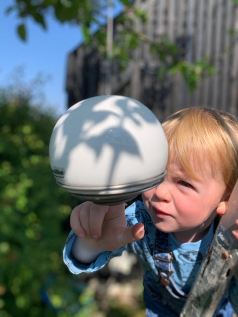 Carrie butcher child holding a belle birdfeeder