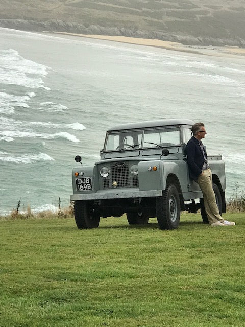 Land rover on the cornish coast with male model