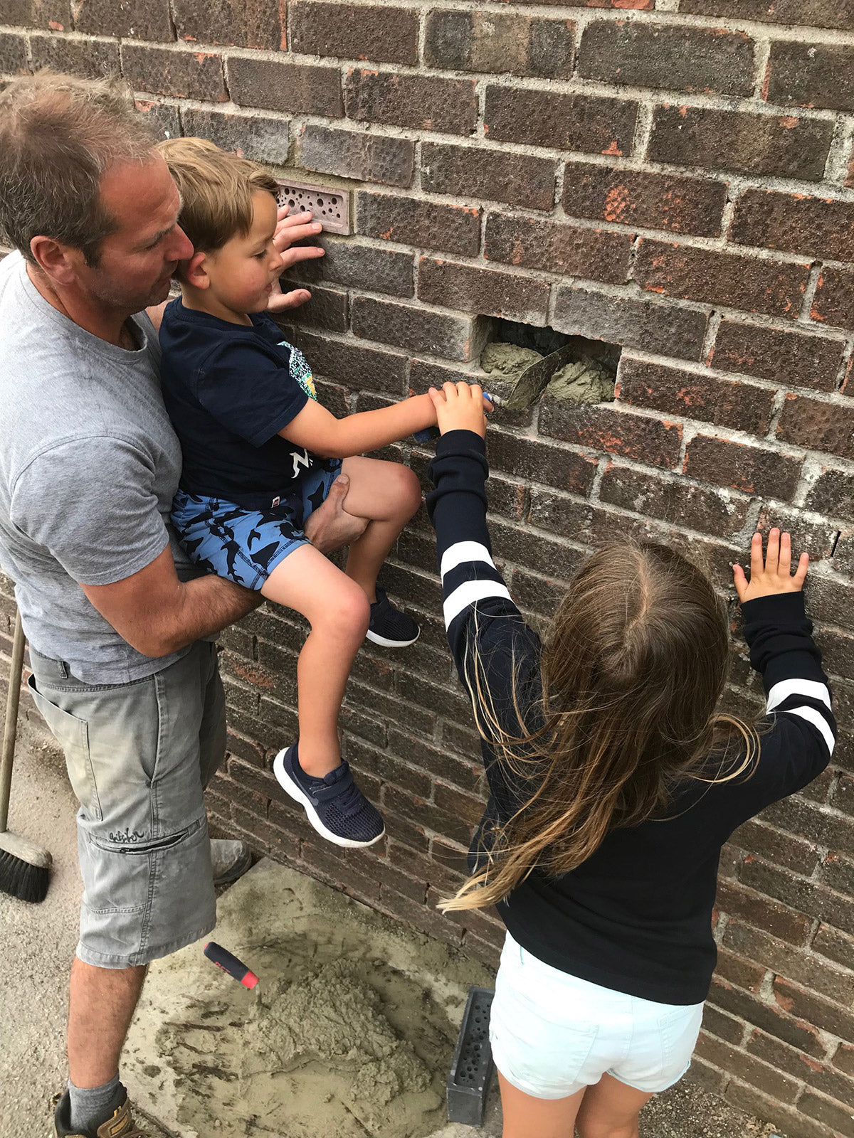 Installing a bee brick into brick wall