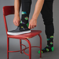 A man wearing fun Teenage Mutant Ninja Turtle socks