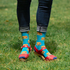 A woman wearing fun burger socks with red heeled sandals
