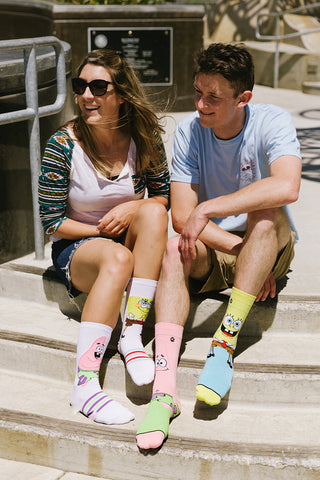 A woman and man wearing fun SpongeBob SquarePants socks