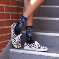 A woman wearing Starry Night novelty socks