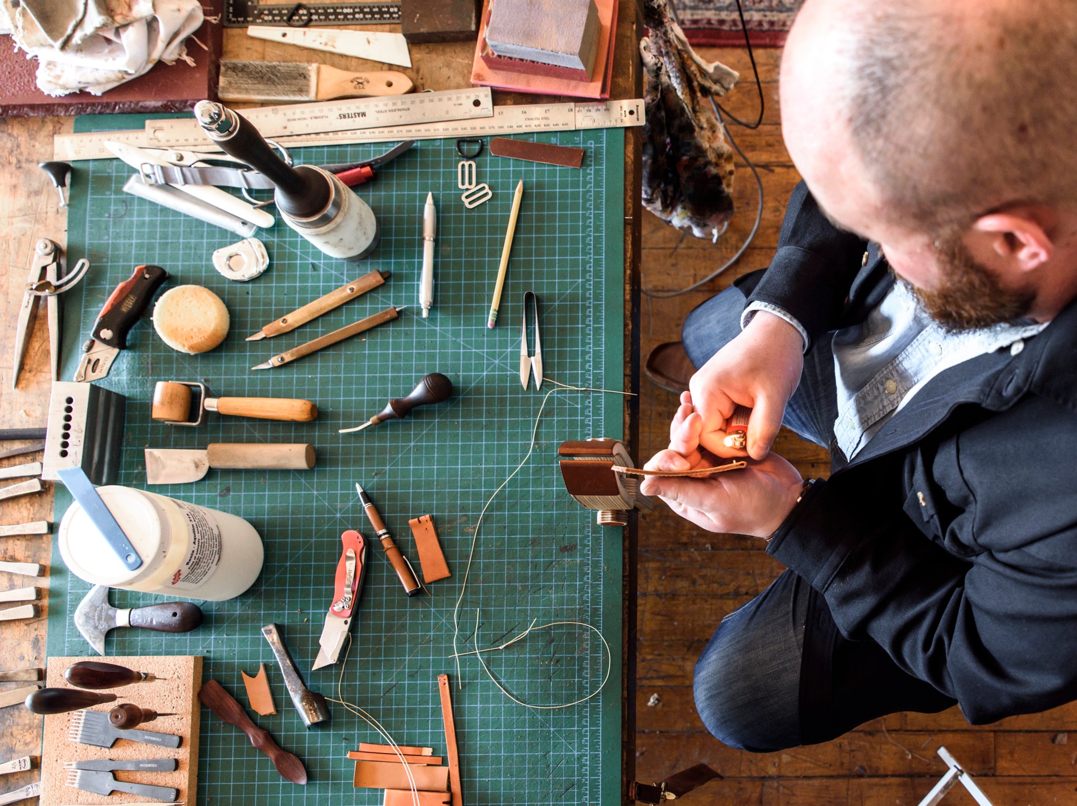 Aerial view of david lane working on leather in his studio