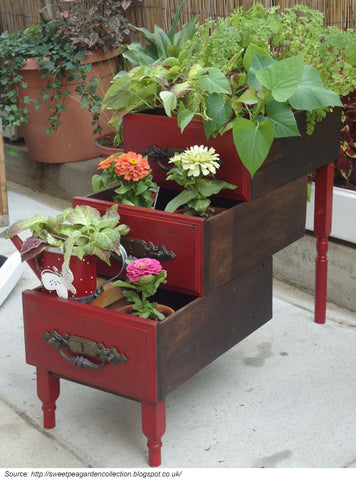 upcycled furniture being used as flower planters
