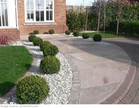 paved garden with shrubs and gravel