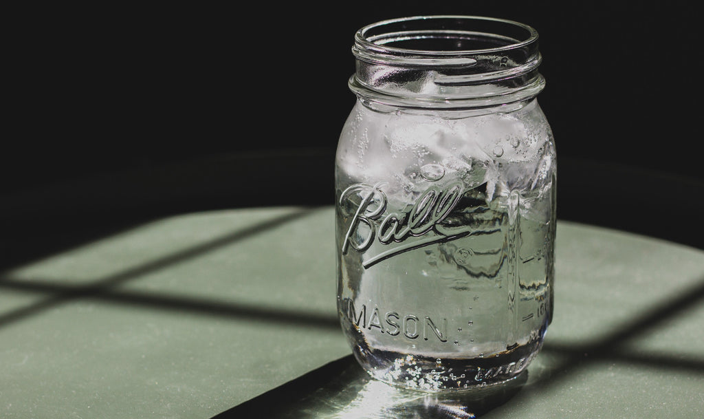 a mason jar of water by ethan sykes