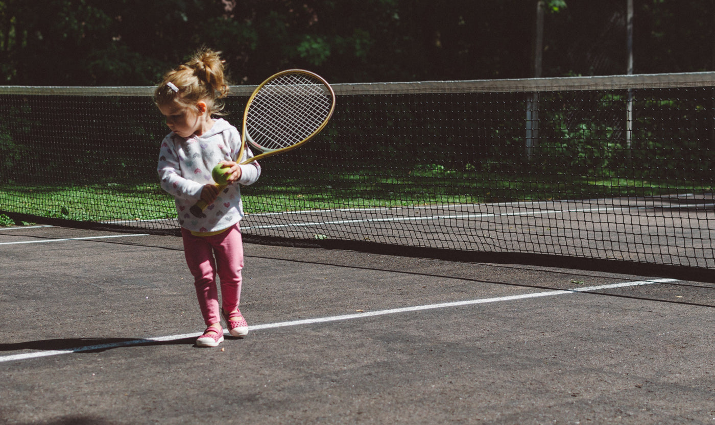 bare-biology-omega-3-a-little-girl-on-a-tennis-court
