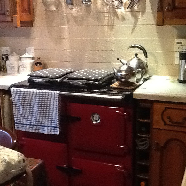 Red Rayburn range cooker with towel and chefs pads