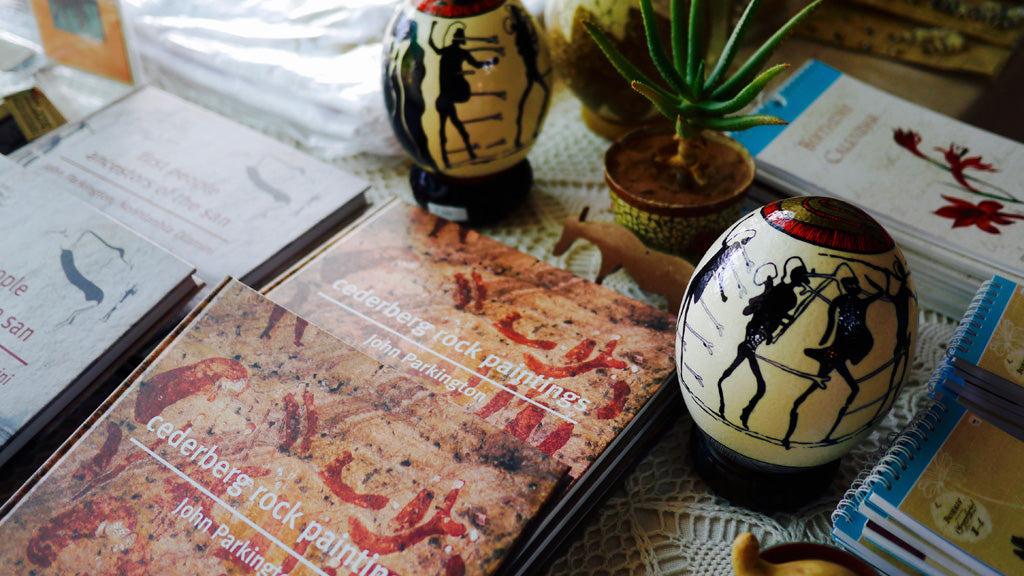 Some of John Parkington's books, and painted ostrich egg shells inspired by San rock art, on sale at the Clanwilliam Living Landscape Project pop up