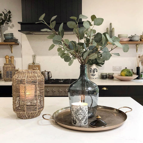 The Amazon candle glowing beautifully, picture by @mydarkhome - on the right is the Zambezi Diffuser styled lovingly styled by @the_girl_with_the_green_sofa