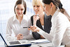 Three businesswomen at a computer