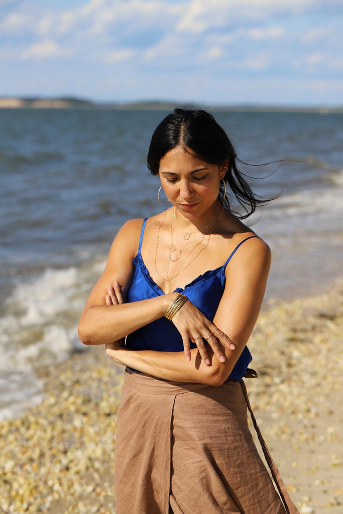 girl on beach with layered jewelry