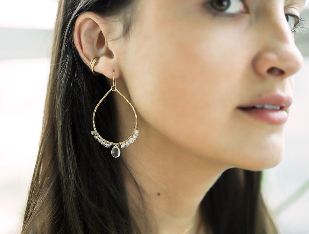 crystal quartz and gold arc earrings by delia langan jewelry