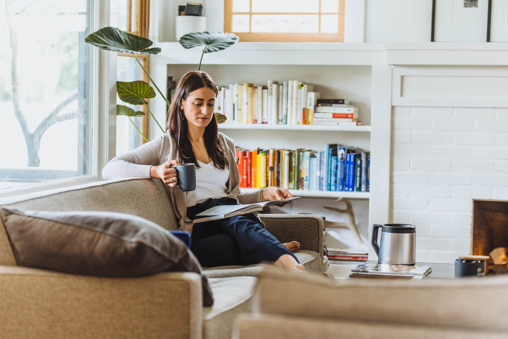 Woman drinking Ratio Six coffee in her living room