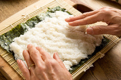 place sushi rice on nori seaweed