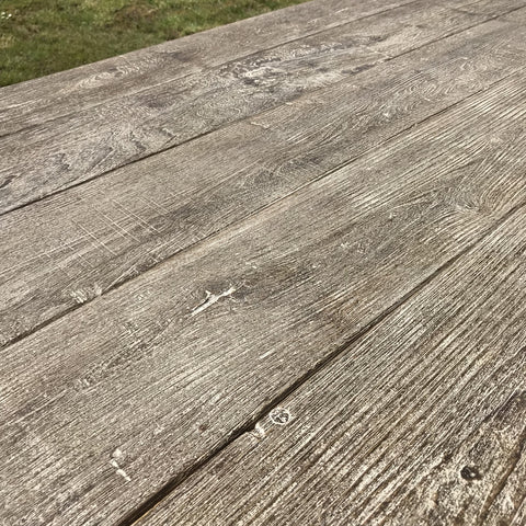 Closeup or Indian grey stained wood dining table