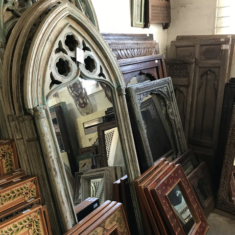 Various ornately carved Indian mango wood and antique mirrors