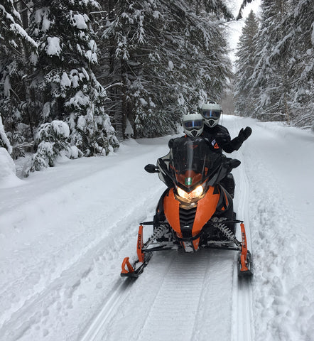 Karen Richardson with her husband on their snowmobile