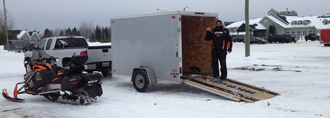 Unloading our snowmobile at Cedar Meadows Resort