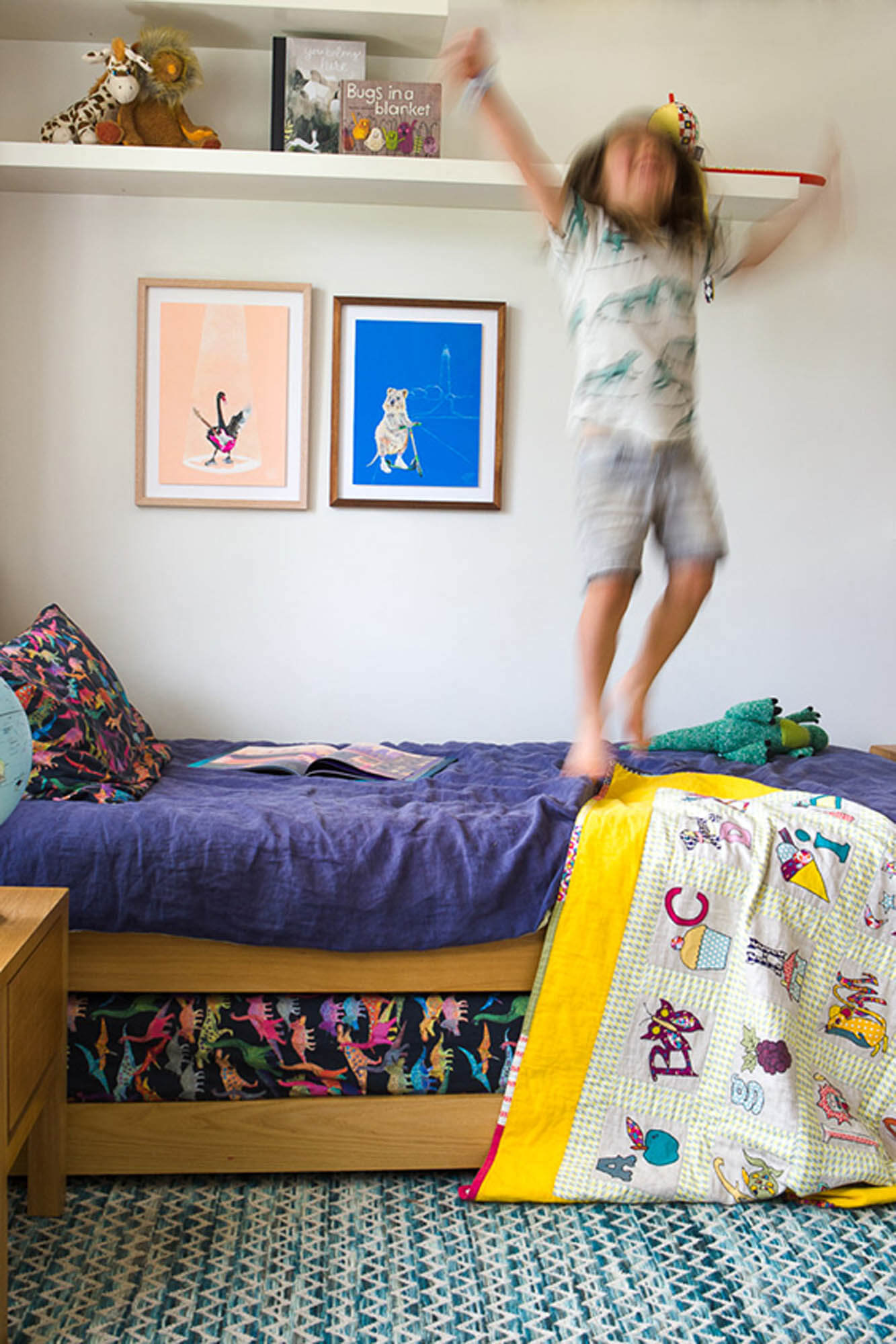Boy jumping on bed, featuring Rottnest Island Quokka print, Bakery Run. 