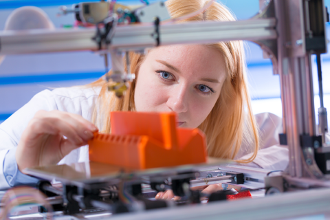Lady inspecting her 3D Print